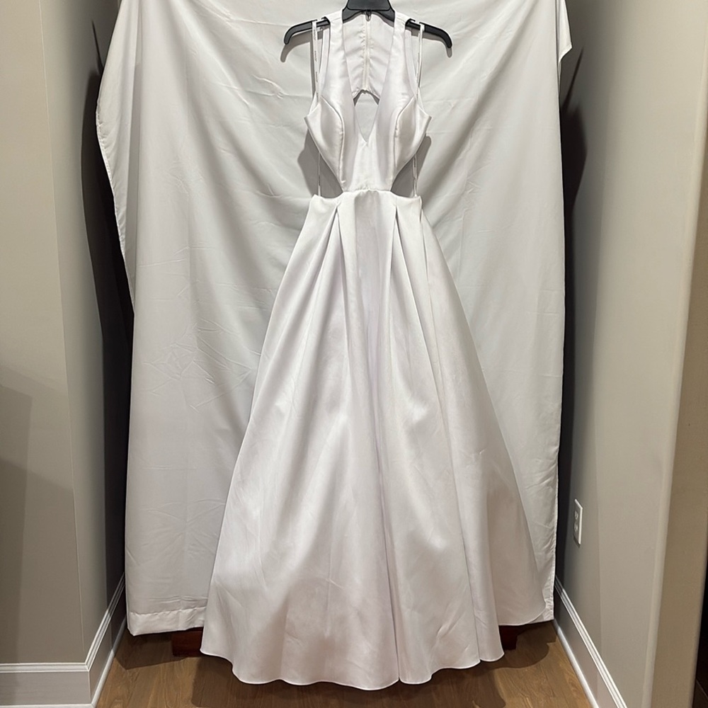 Beautiful Jovani, white, pageant or prom dress with cut outs at midriff.